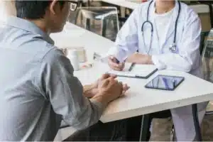 Addiction treatment doctor meeting with a patient to discuss recovery plan and medication options.