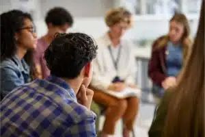 Group therapy session at a private alcohol rehab center where individuals participate in counseling and recovery discussions.
