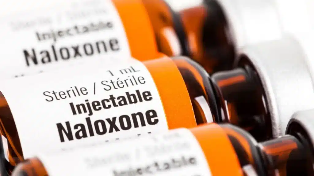 Photo showing fentanyl test strips, naloxone kits, and harm-reduction supplies.