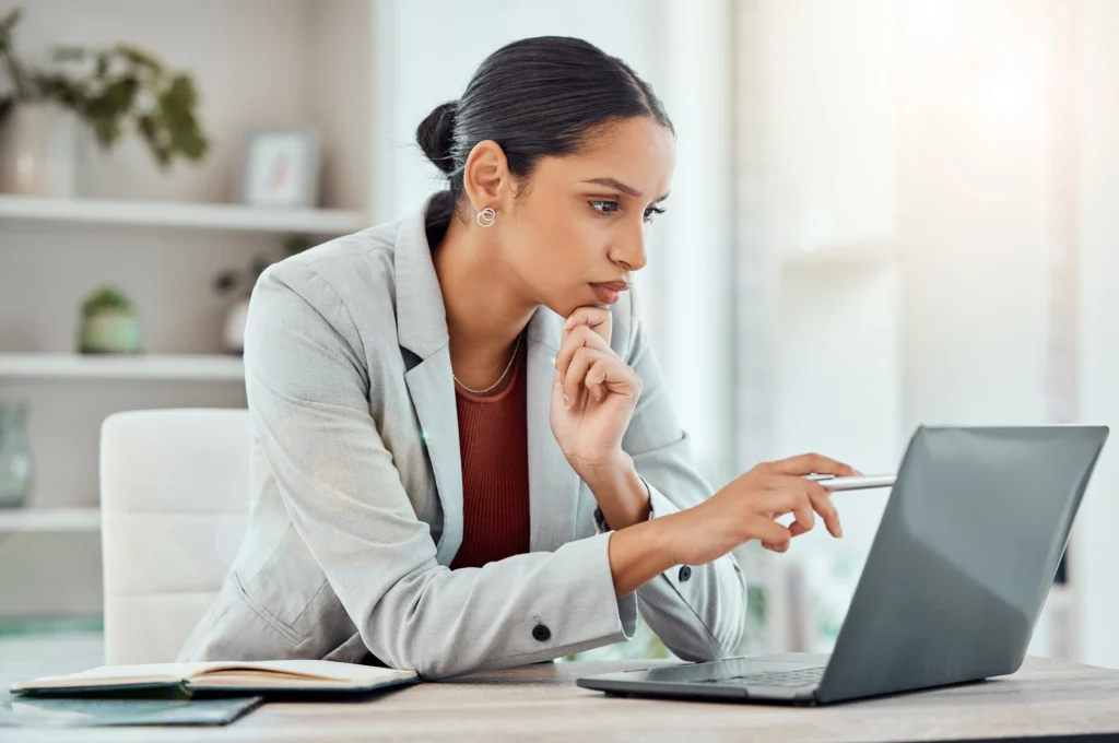 Woman researching addiction treatment options in New Jersey on a laptop while reviewing support resources online.